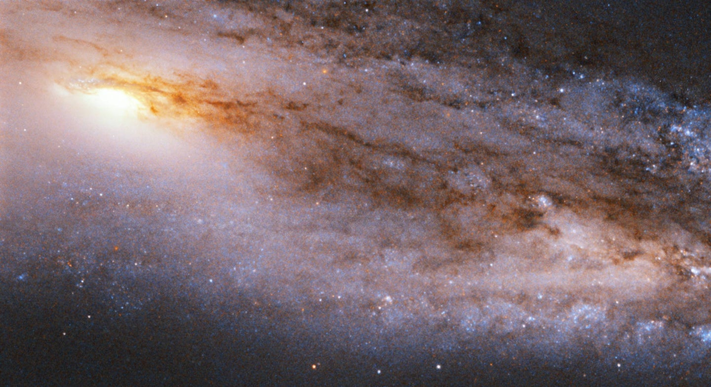 Cosmic dust on display in Messier 98 galaxy.