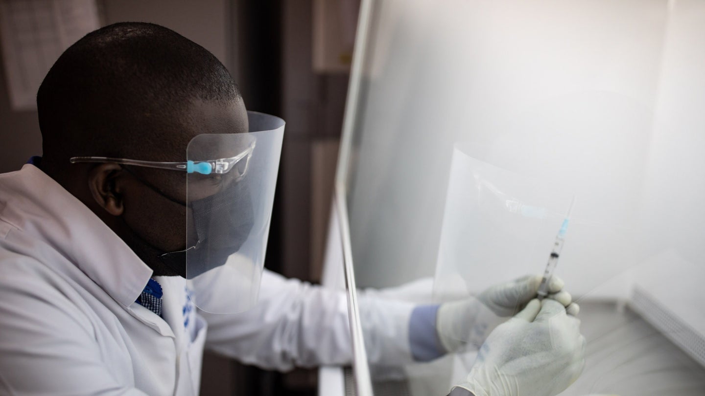A vaccine pharmacist prepares blind samples as part of an HIV vaccine trial on March 16, 2022 in Masaka, Uganda.
