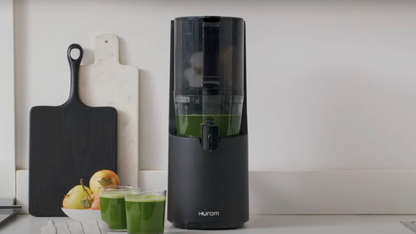 A Hurom juicer sitting on a kitchen counter