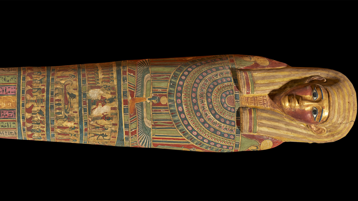 A mummy's coffin on a dark background.
