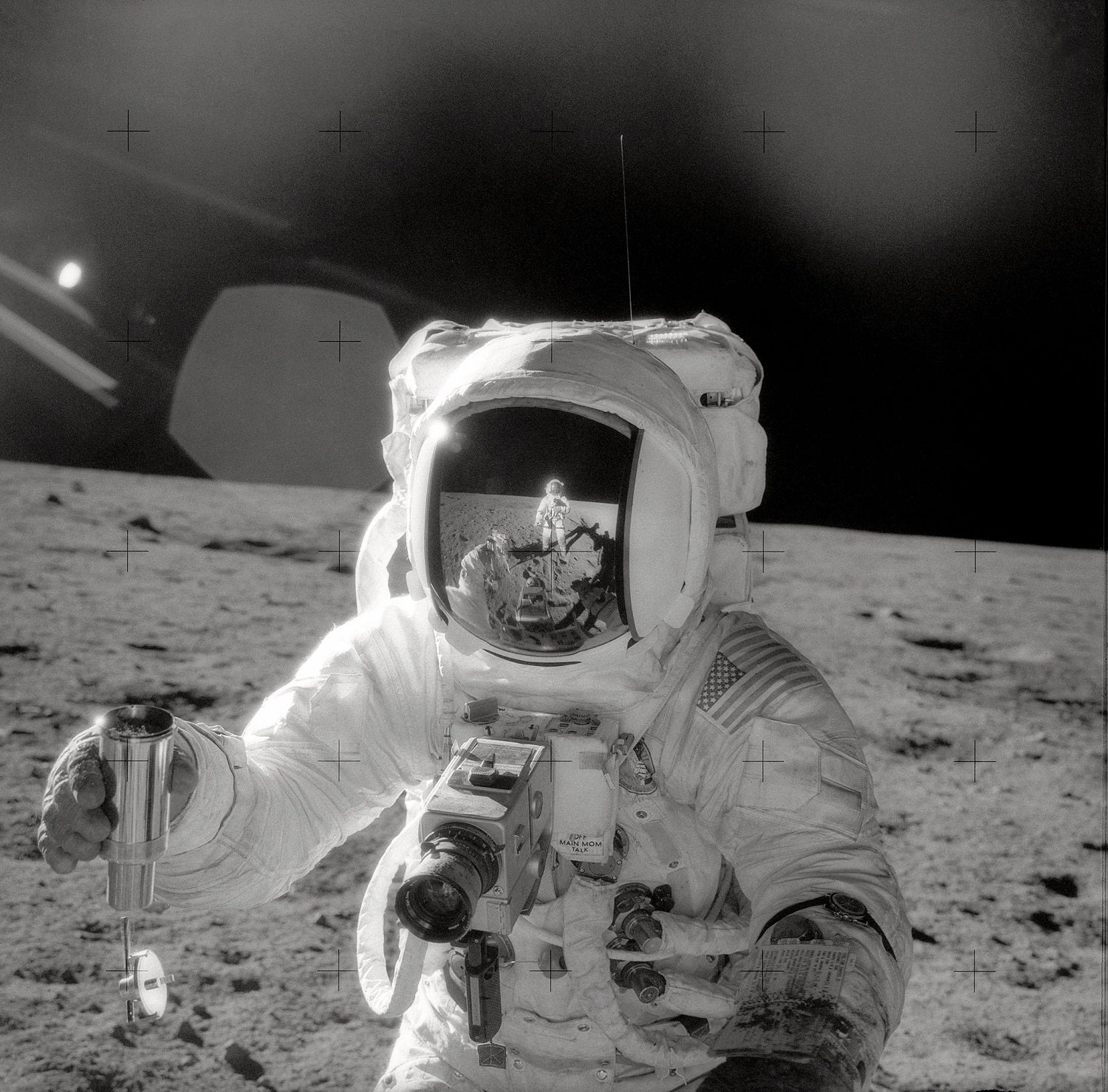 Apollo 12 astronaut on moon holding lunar sample to help determine how old the Earth is