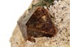 Brown Zircon mineral against white can be used to determine how old the Earth is