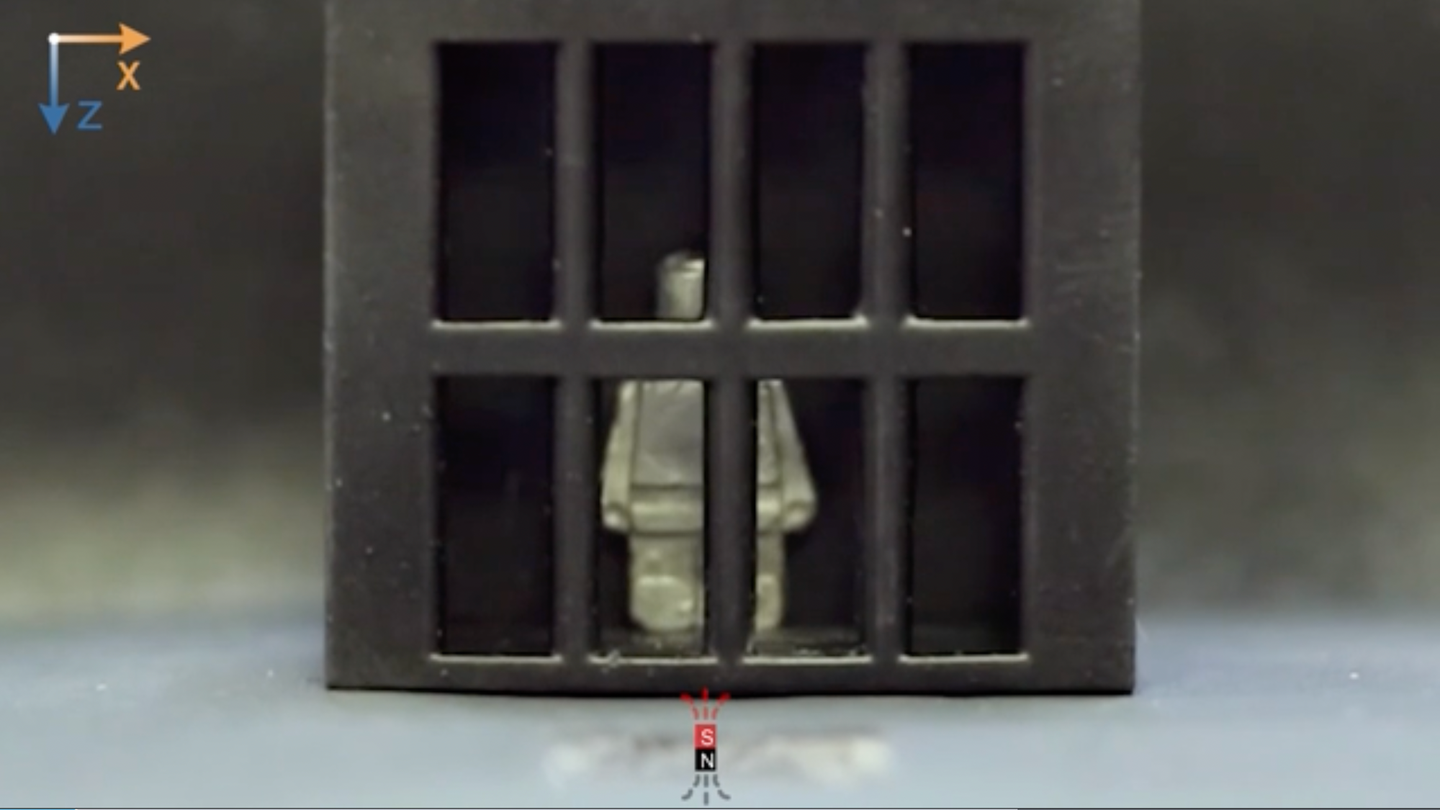Lego man liquid-metal model standing in mock jail cell