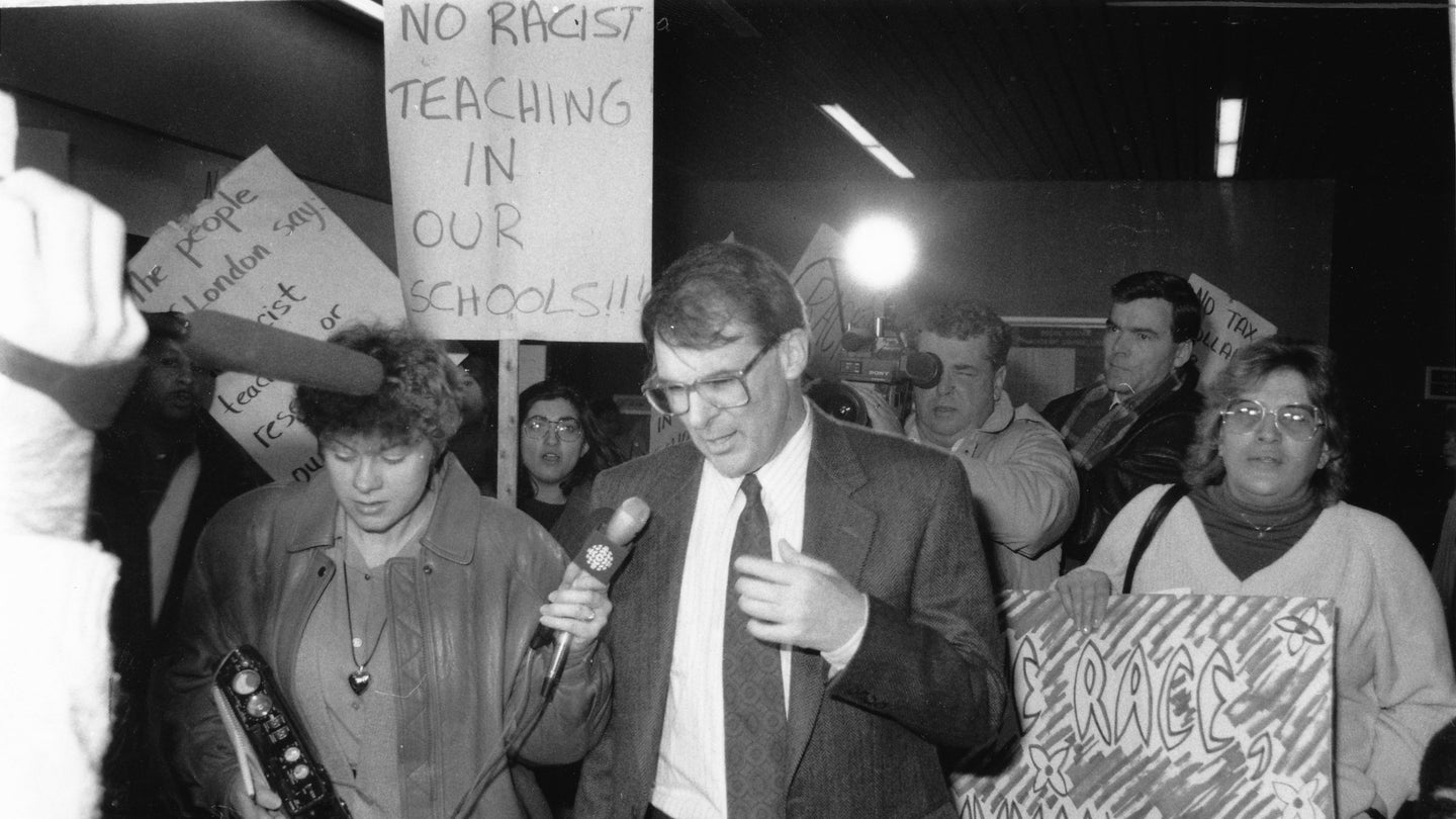 Reporters and protesters surround psychology professor J. Philippe Rushton at the University of Western Ontario after a lecture in 1991. Biosocial criminologists have drawn on Rushton’s blatantly racist work for years.