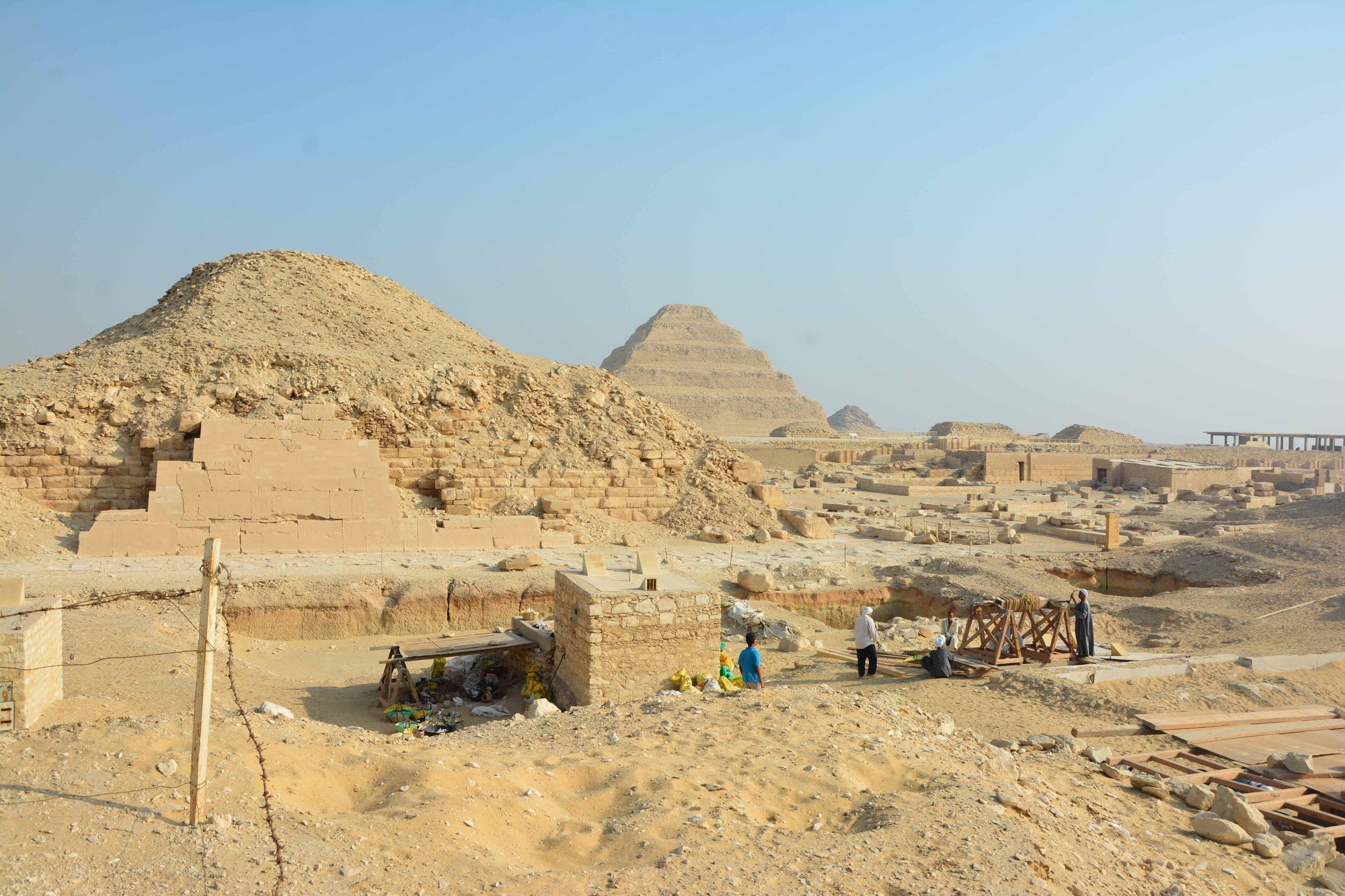 an excavation site of archaeologists working at a pyramid