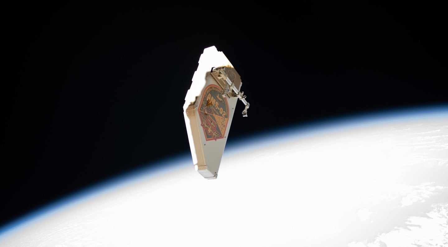 A debris shield floats in space outside the International Space Station.