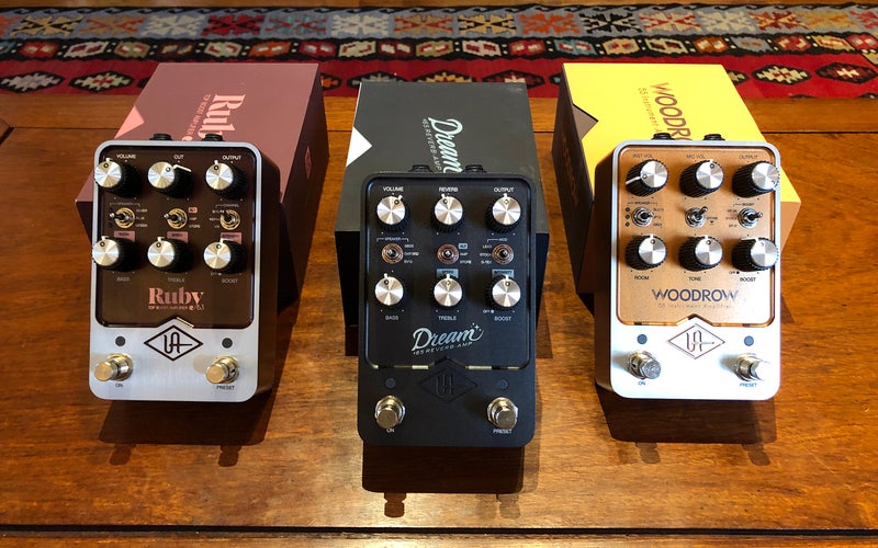 Universal Audio guitar pedals side-by-side in front of their boxes