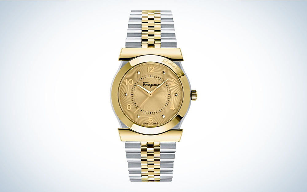 A gold and silver-toned Salvatore Ferragamo Men's watch on a blue and white background