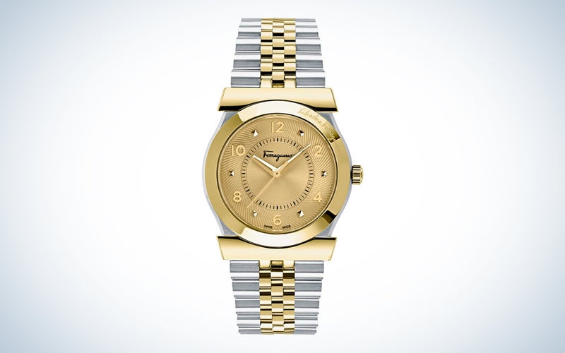 A gold and silver-toned Salvatore Ferragamo Men's watch on a blue and white background