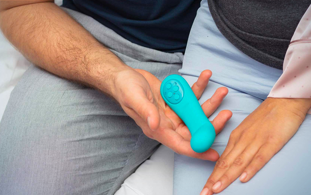 Two people holding a turquoise vibrator