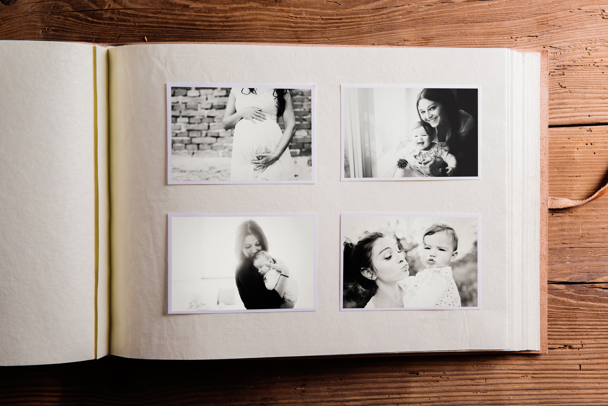 Mother and baby in black and white photos in an album to show postpartum depression vs. postpartum psychosis