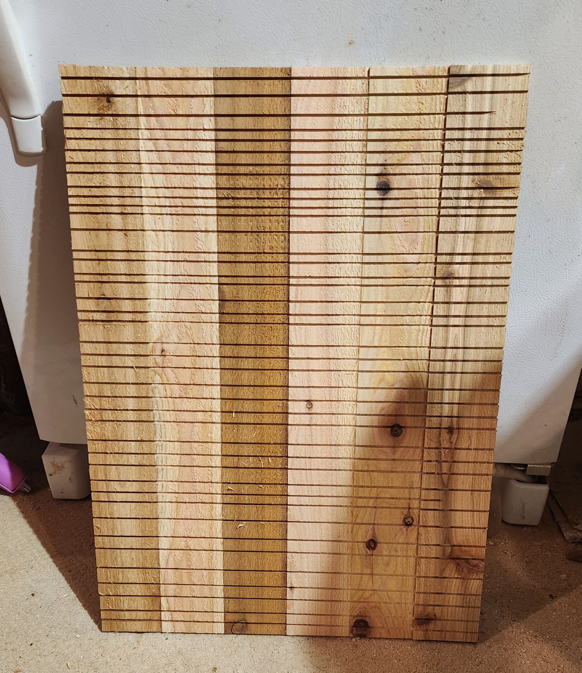 An interior panel for a DIY bat house, with groves cut into it for the bats to hold onto.