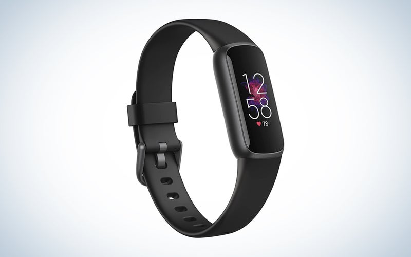 A Fitbit Luxe on a blue and white background