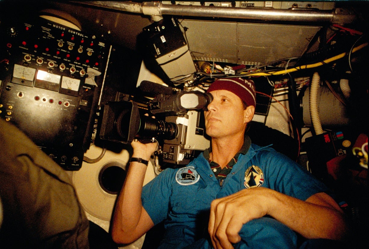 Robert Ballard holds a camera aboard the submersible vehicle Alvin when it dove on the Titanic wreckage.