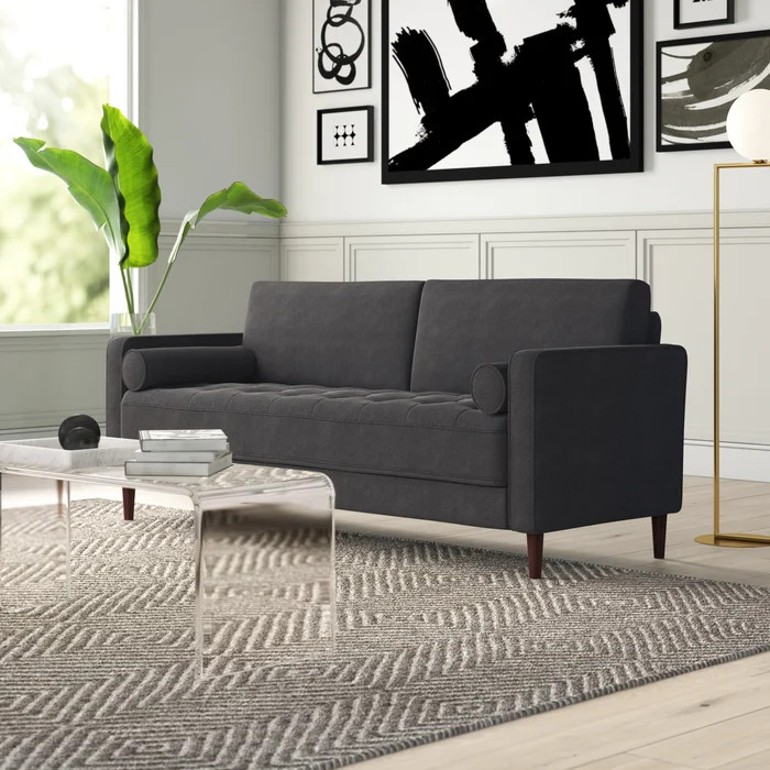 A grey sofa sitting in a living room