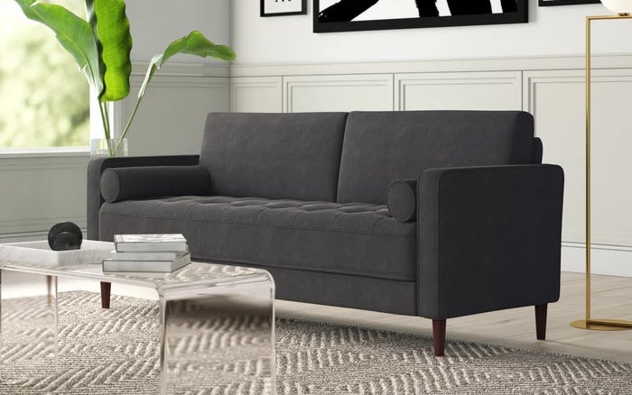 A grey sofa sitting in a living room