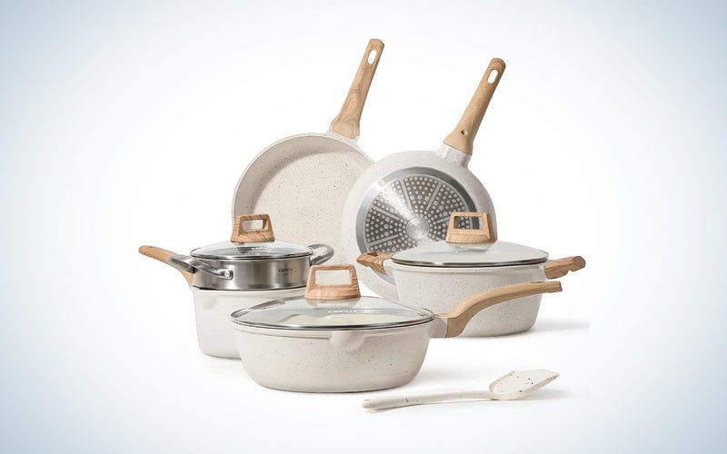 Carote induction cookware set in cream color on a plane background.