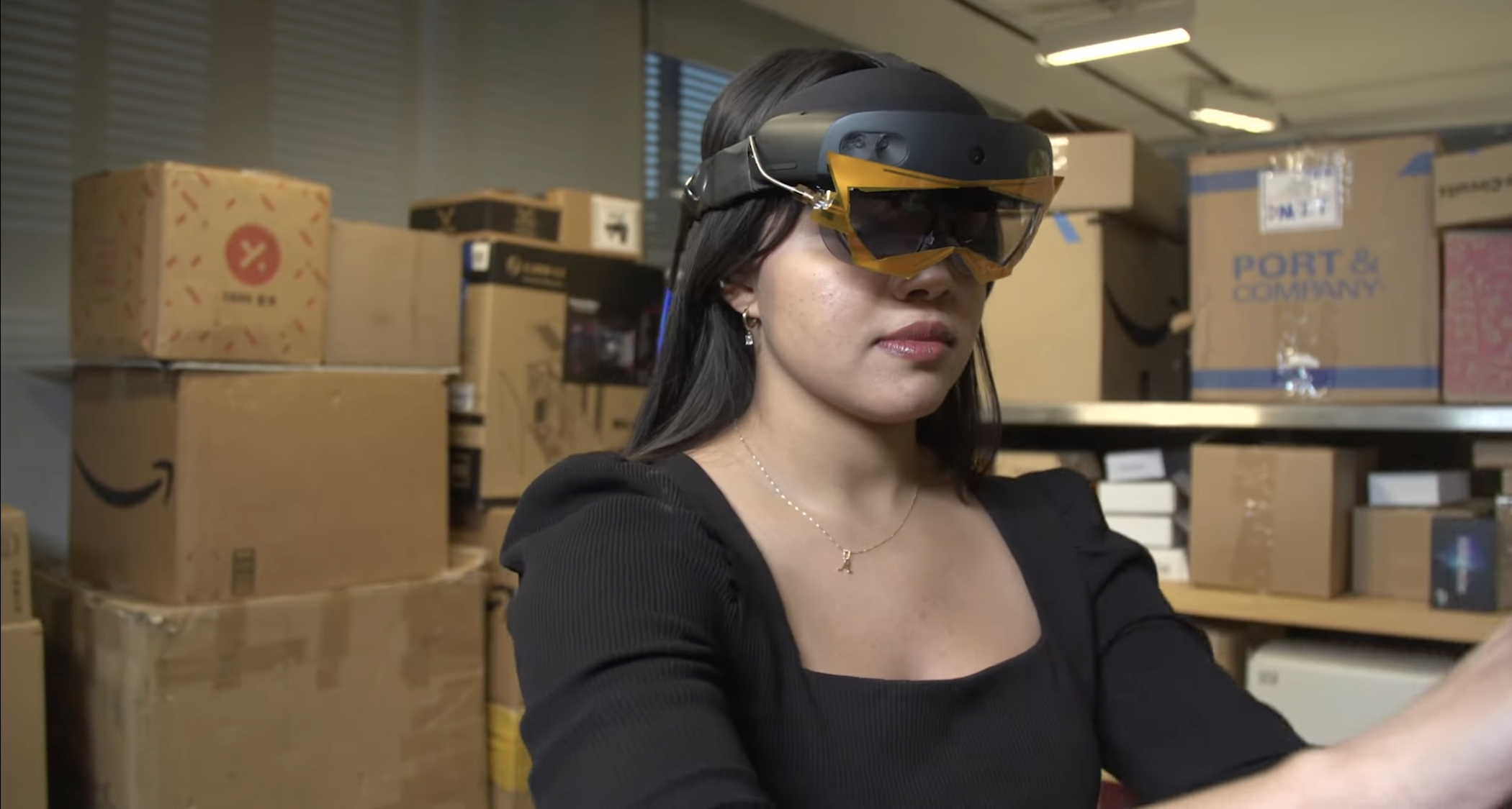 Woman wearing Microsoft Hololens with RFID-tracking antenna addition
