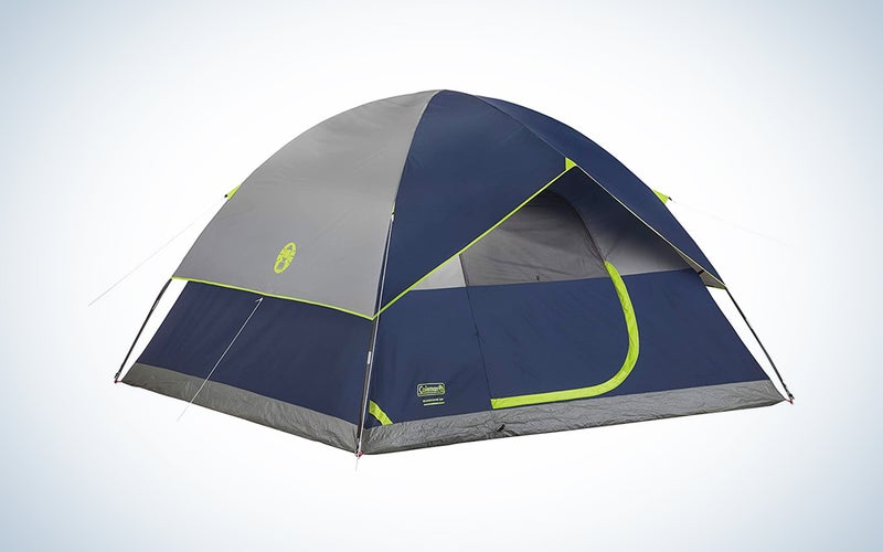 A navy and lime green Coleman tent on a blue and white background