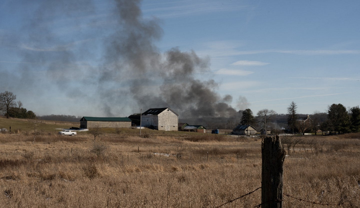 Smoke from the Ohio train derailment over a small house in East Palestine
