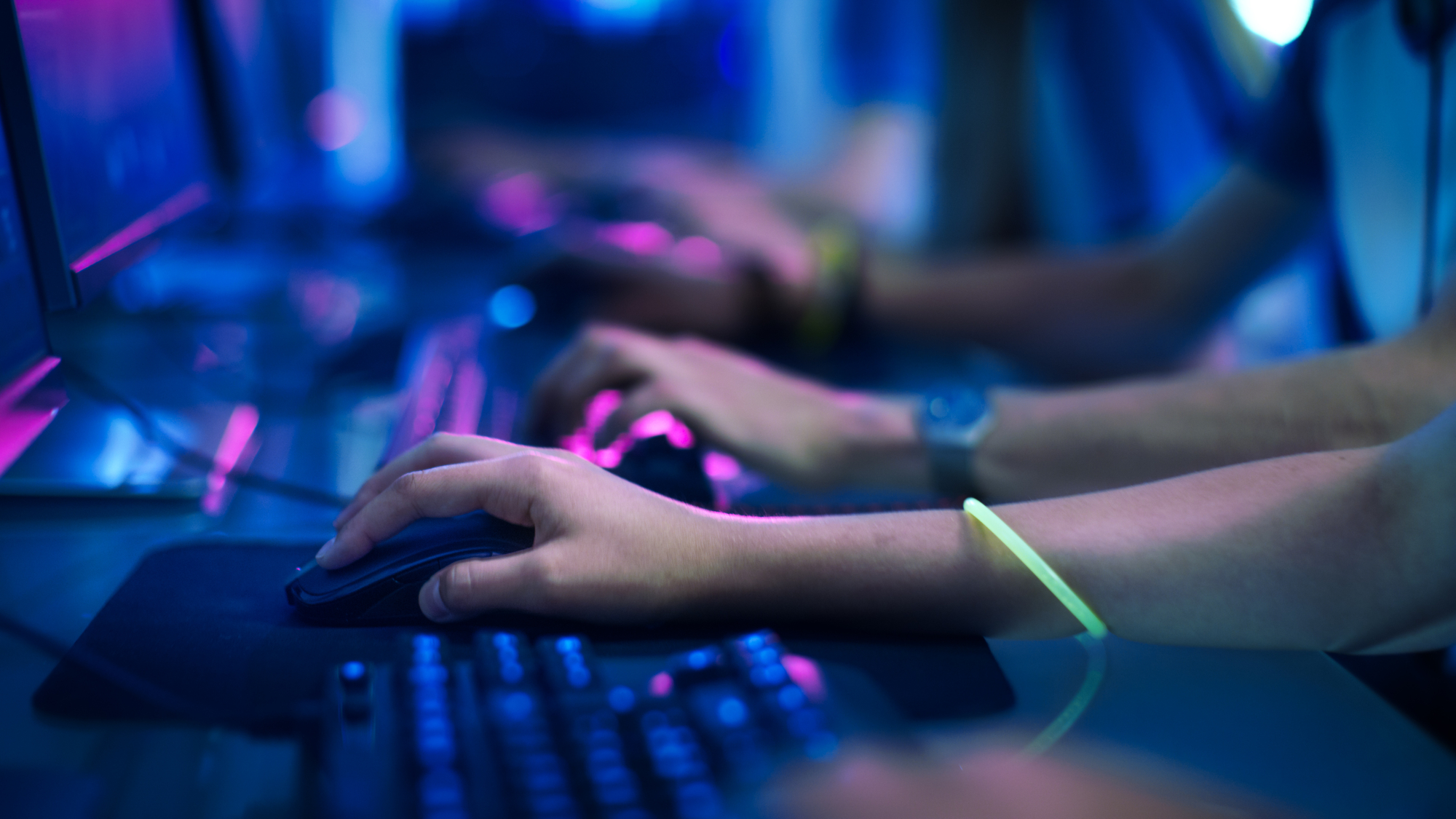 Close-up On row of gamer's Hands on a keyboards