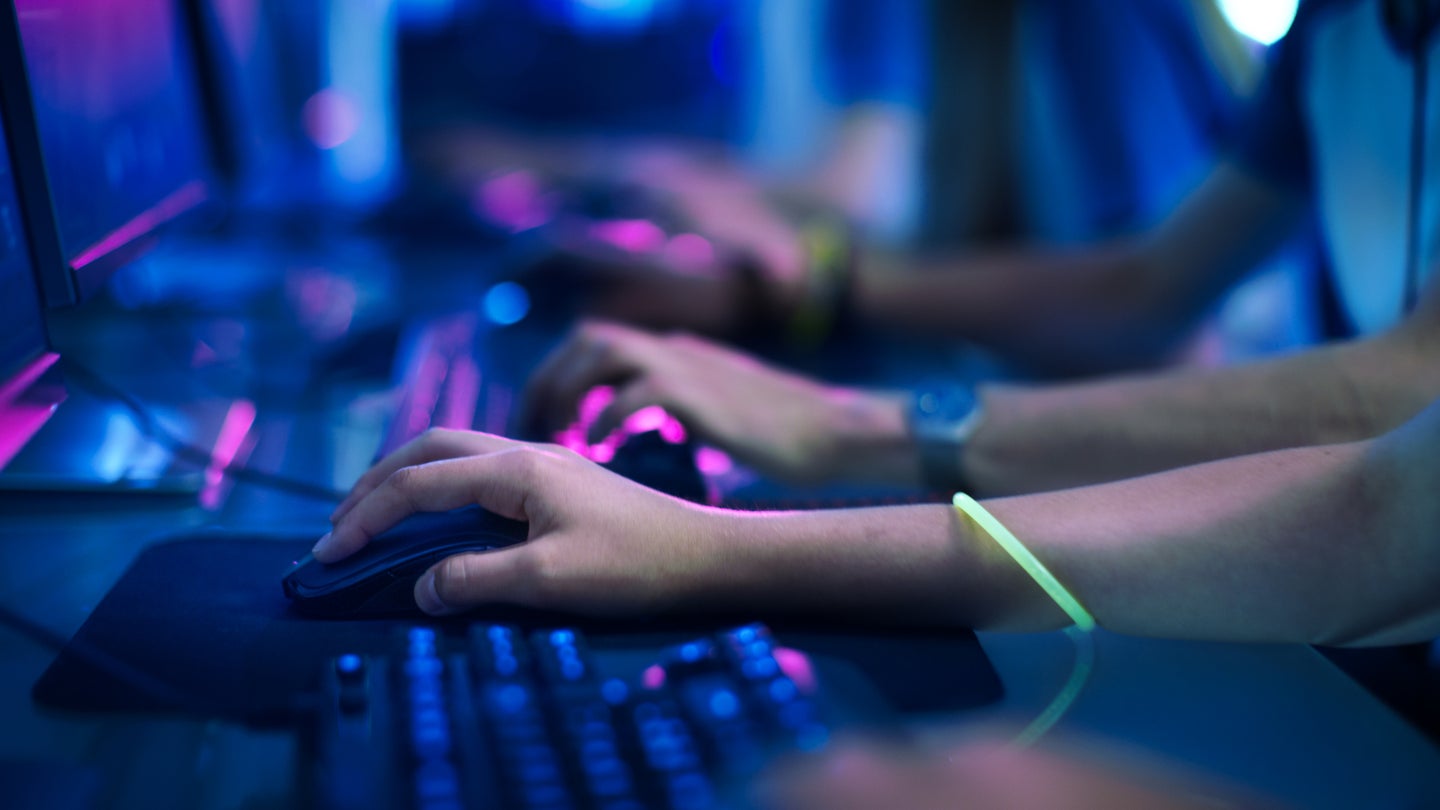 Close-up On row of gamer's Hands on a keyboards