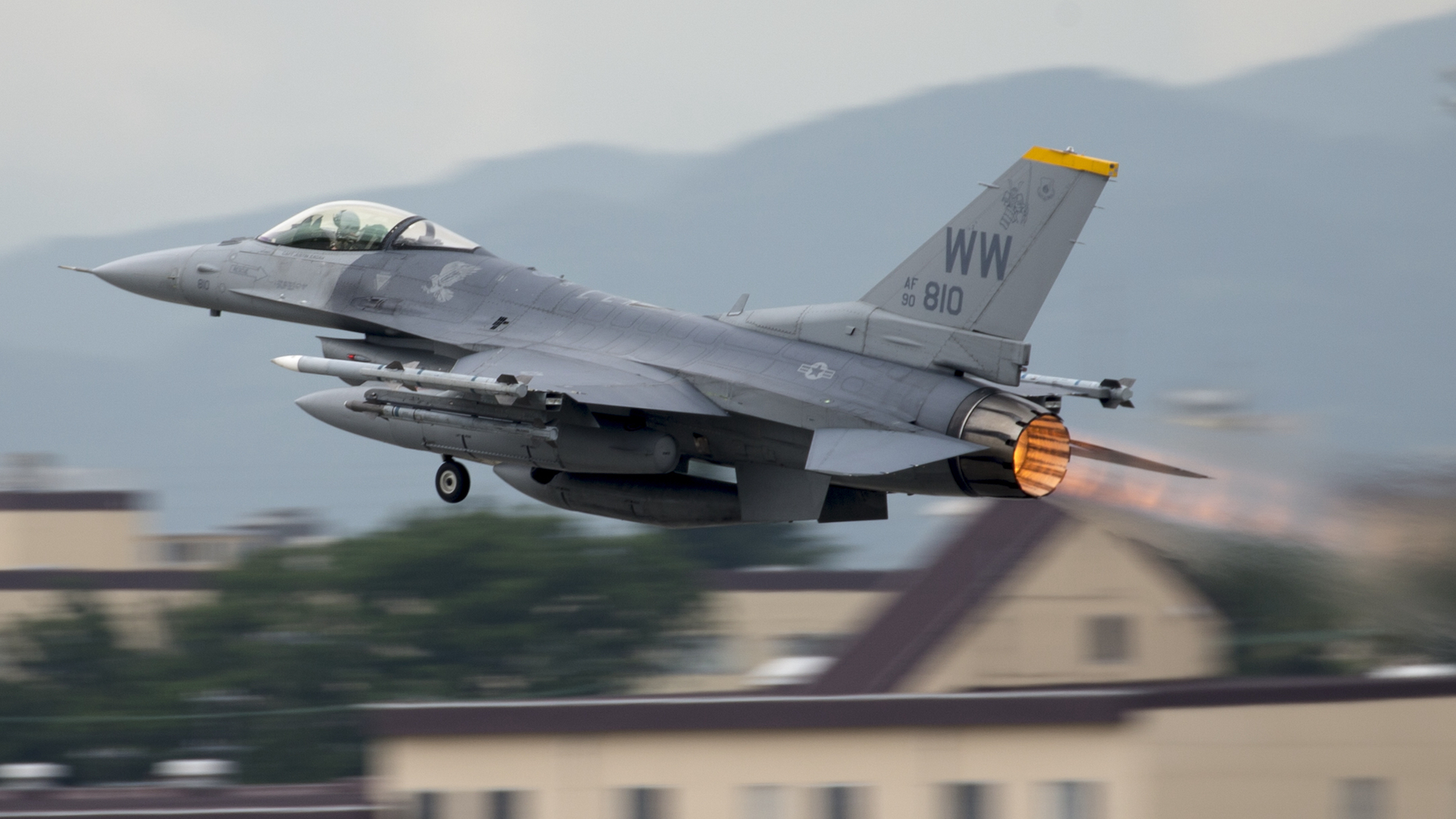 An F-16 with its afterburner lit takes off from a base in Japan in 2016. 