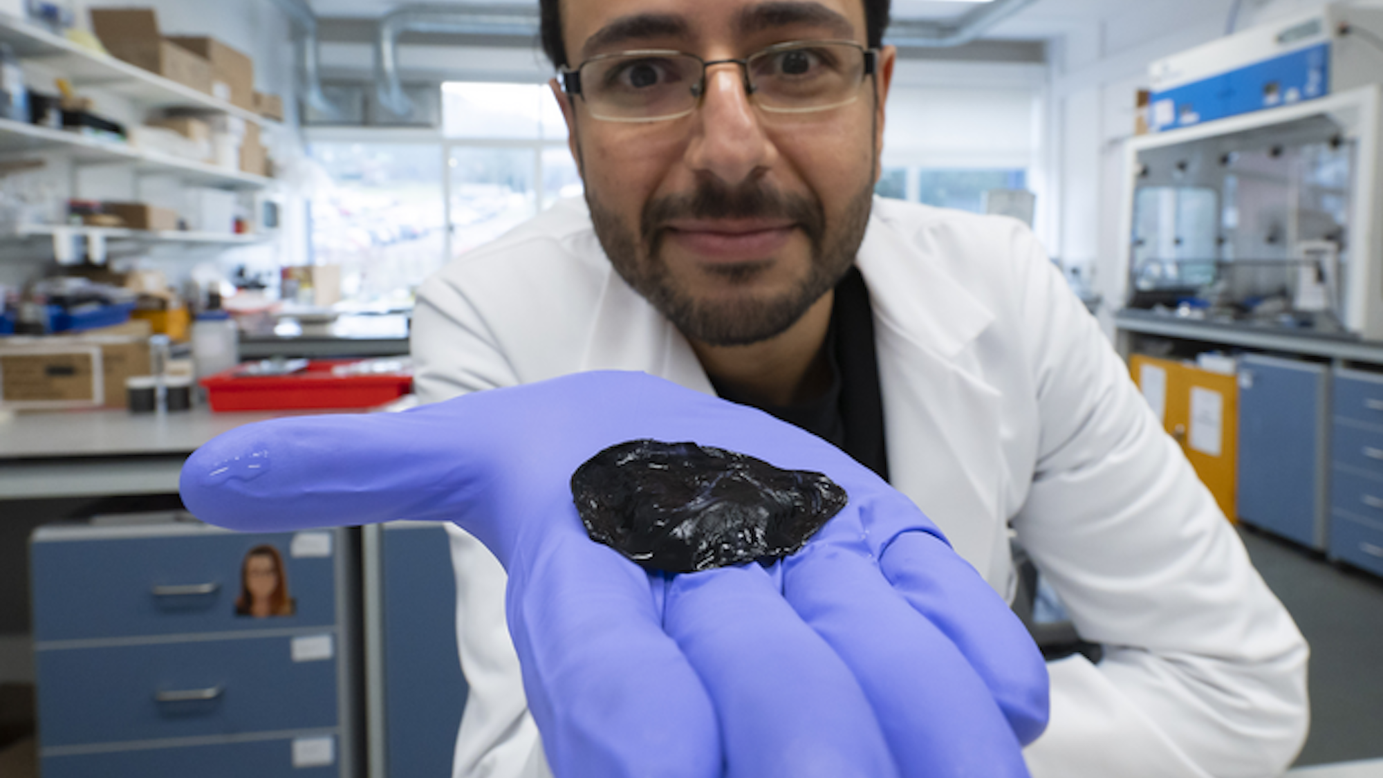 Research student holding graphene seaweed hydrogel in gloved hand