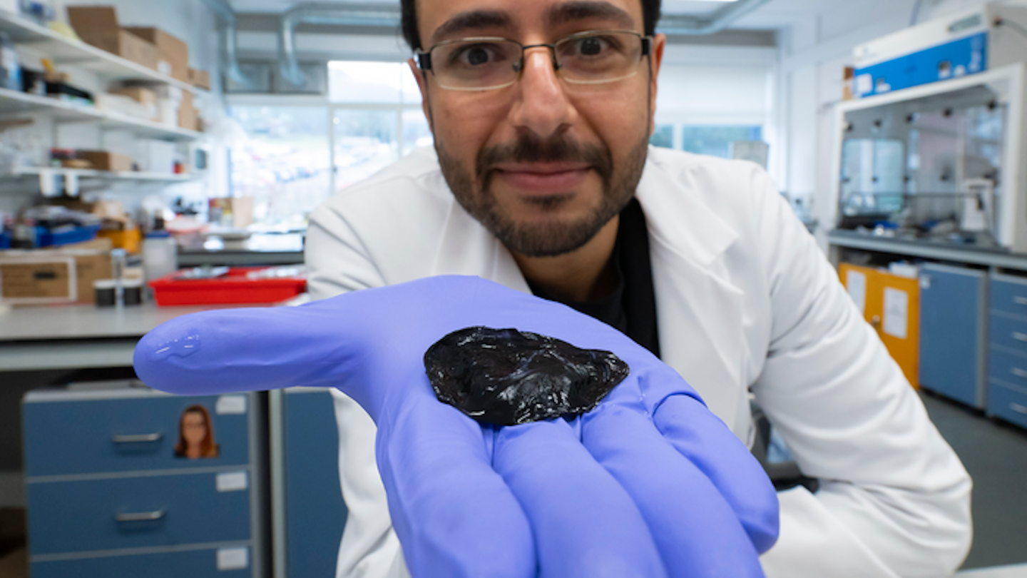 Research student holding graphene seaweed hydrogel in gloved hand