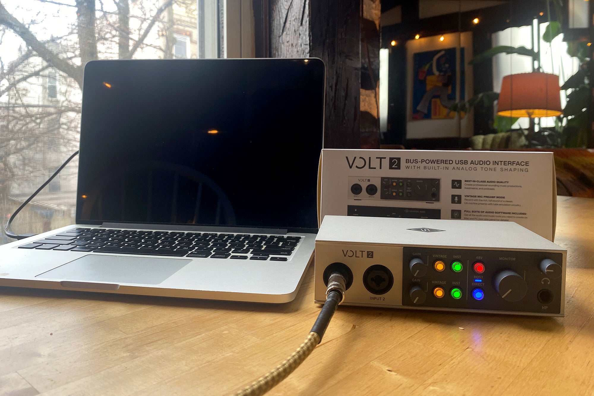 Universal Audio Volt 2 USB-C audio interface next to a MacBook Pro