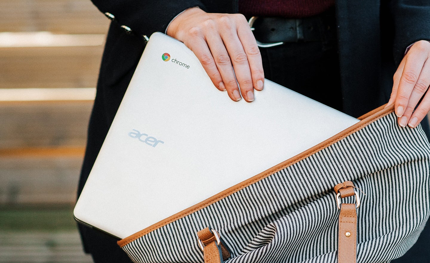 Person putting Chromebook into a bag.