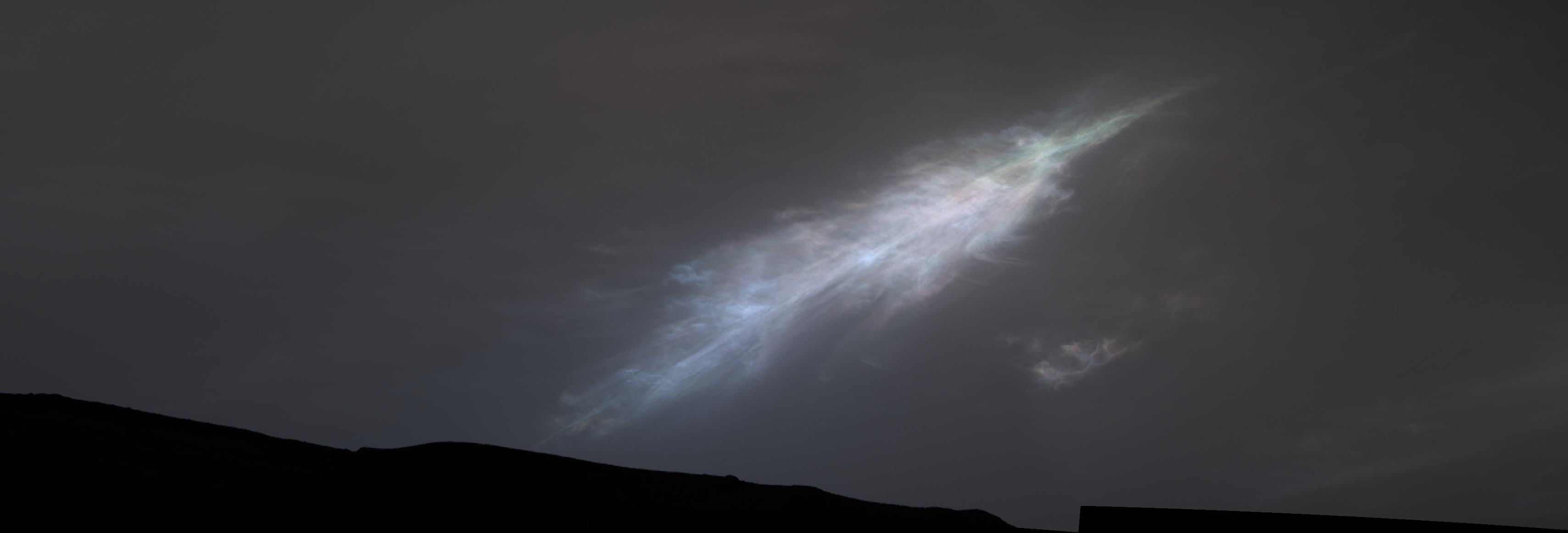 A feather-shaped iridescent cloud just after sunset on Mars.