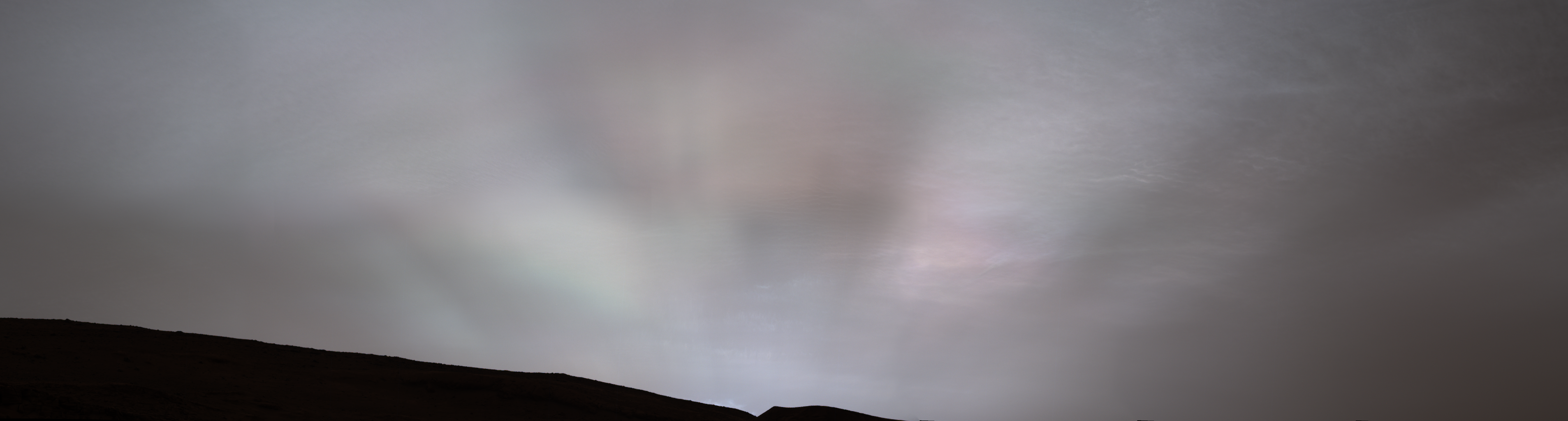 Rays of the sun shining through clouds on Mars during sunset. 