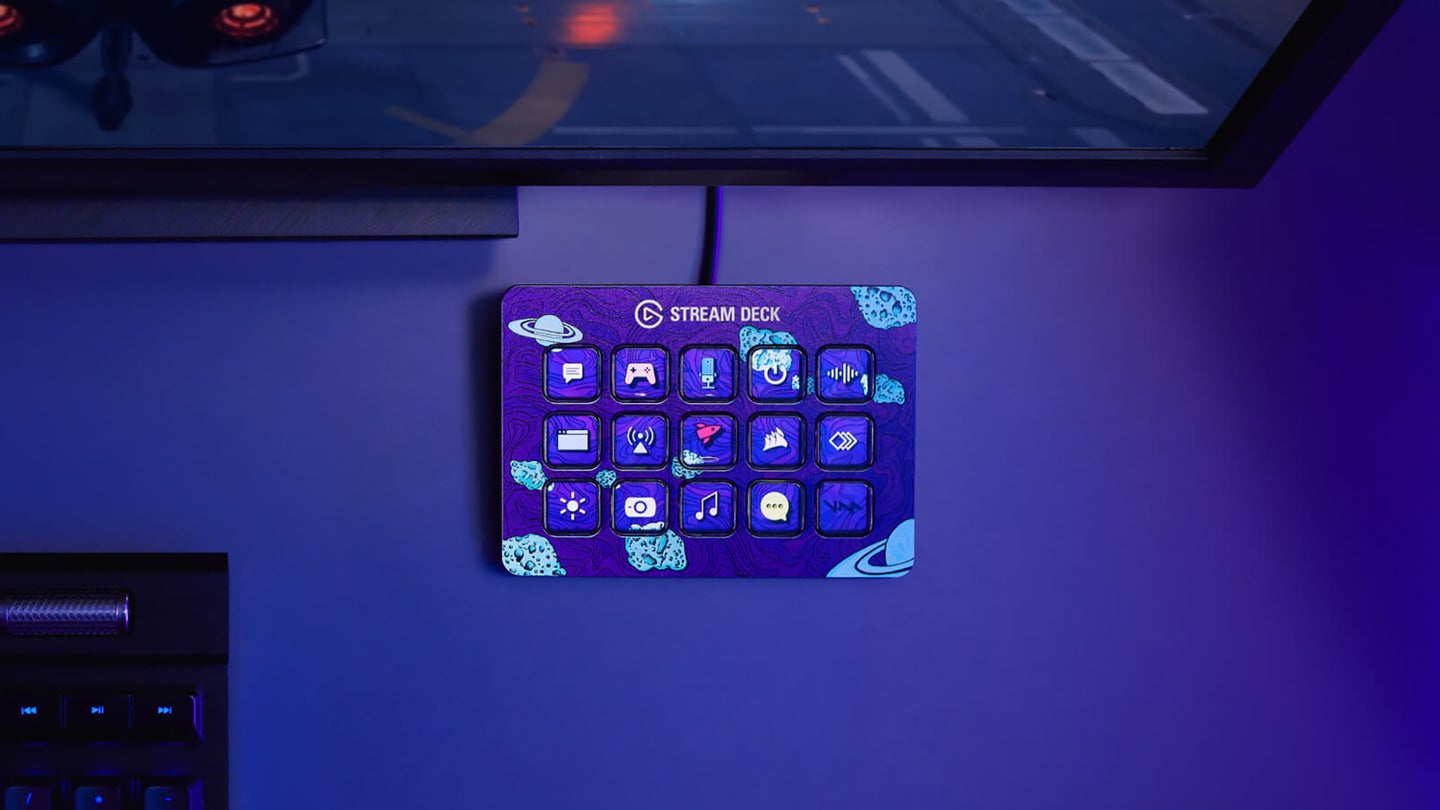An Elgato Stream Deck under a wall-mounted TV, in a room with blue lighting.