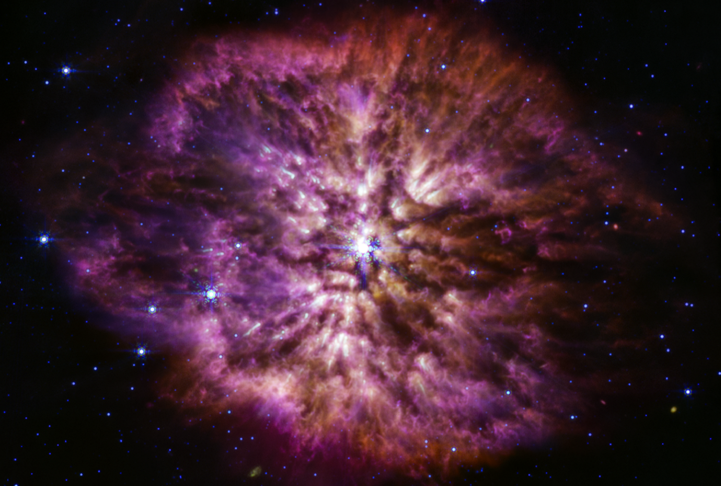 WR 145 star in pre-supernova state with white bright core and red and purple dust and matter clouding around it. Taken by NASA's James Webb Space Telescope.