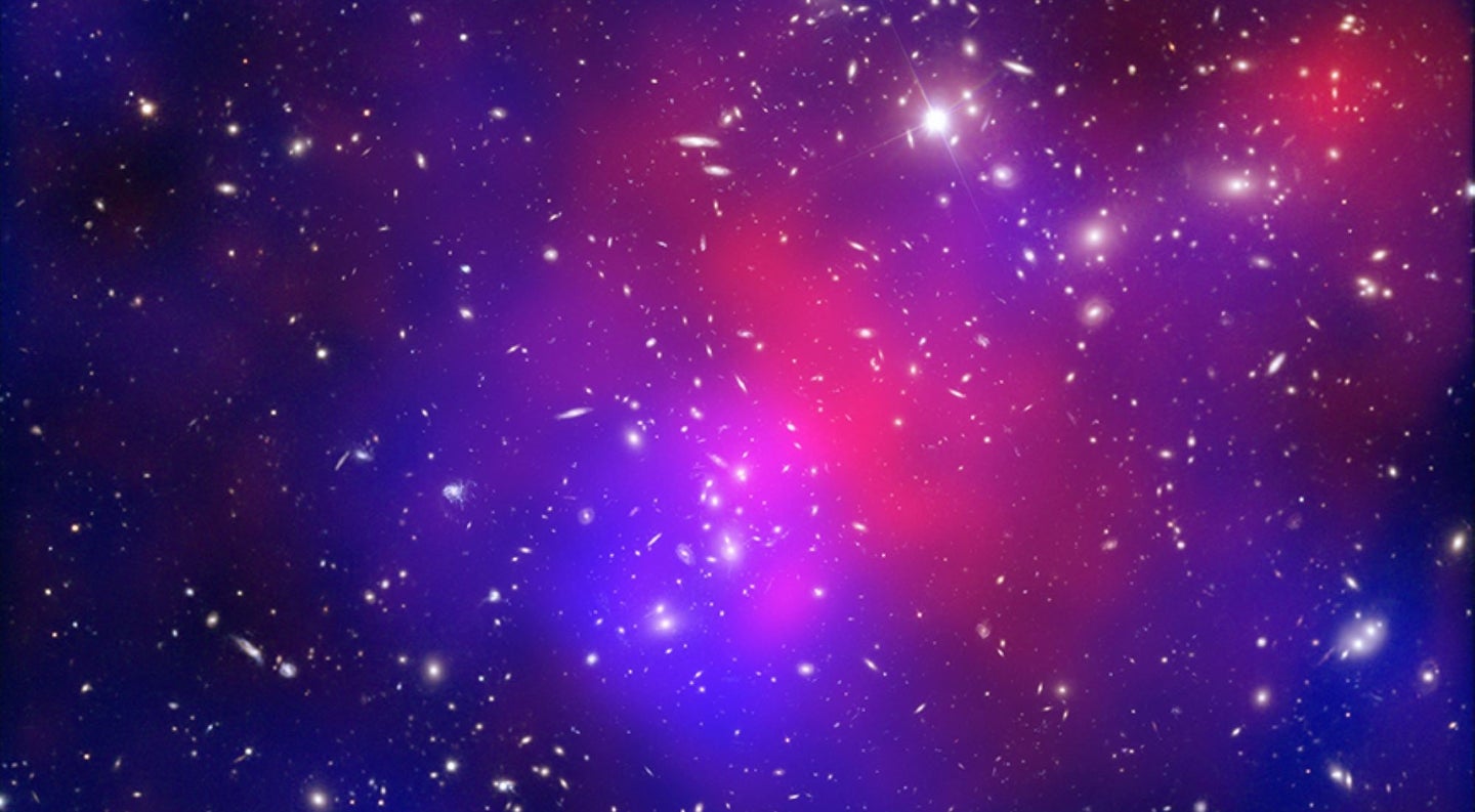 A composite image of colliding galaxies, which make up cluster Abell 2744. The blue represents dark matter, a kindred mystery to dark energy.