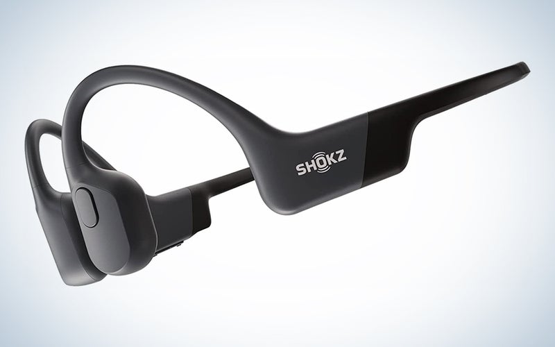 A pair of Shokz OpenRun bone conduction headphones on a blue and white background