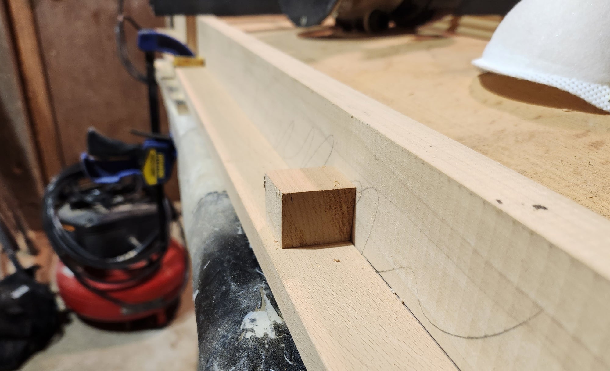 A small wooden square used to brace the rail of a homemade router sled.