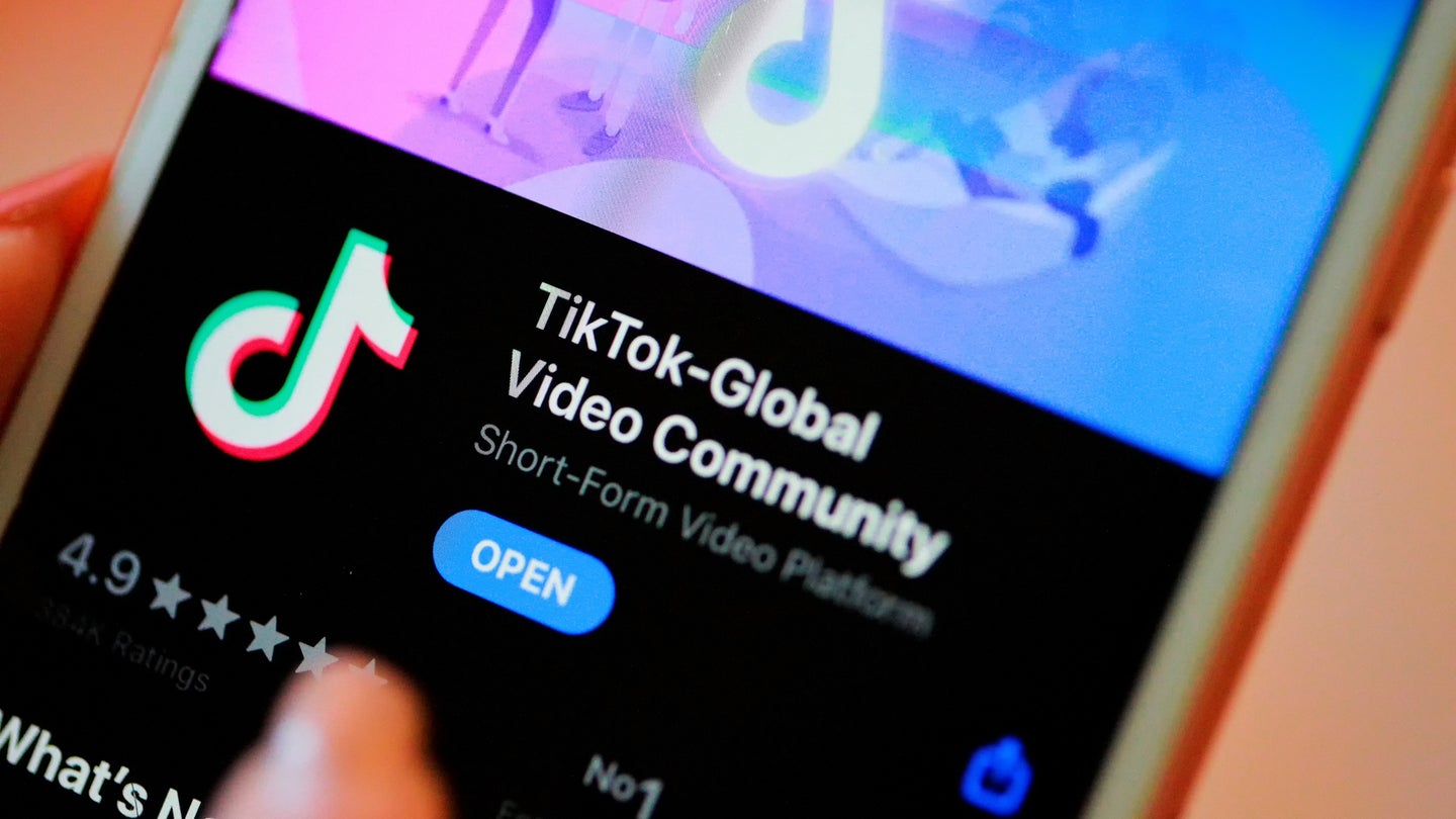 TikTok app information icon on Apple iPhone 8 close-up