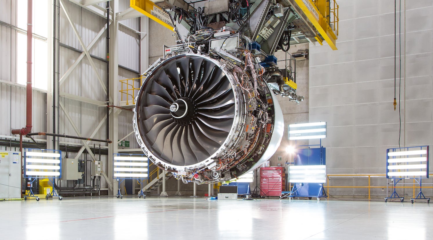 A Trent XWB jet engine hanging in an aircraft hanger.