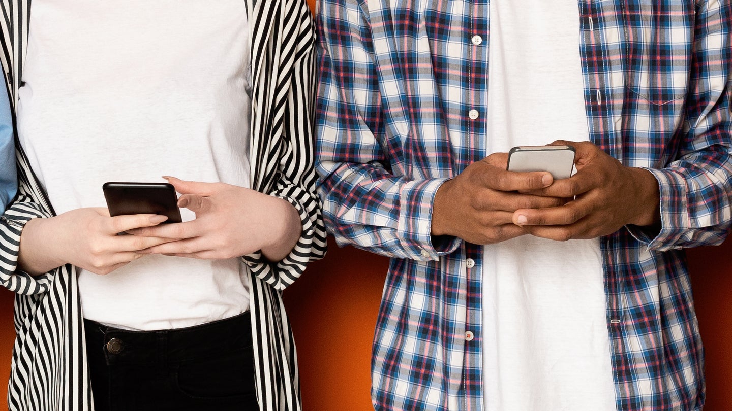Two people holding smartphones