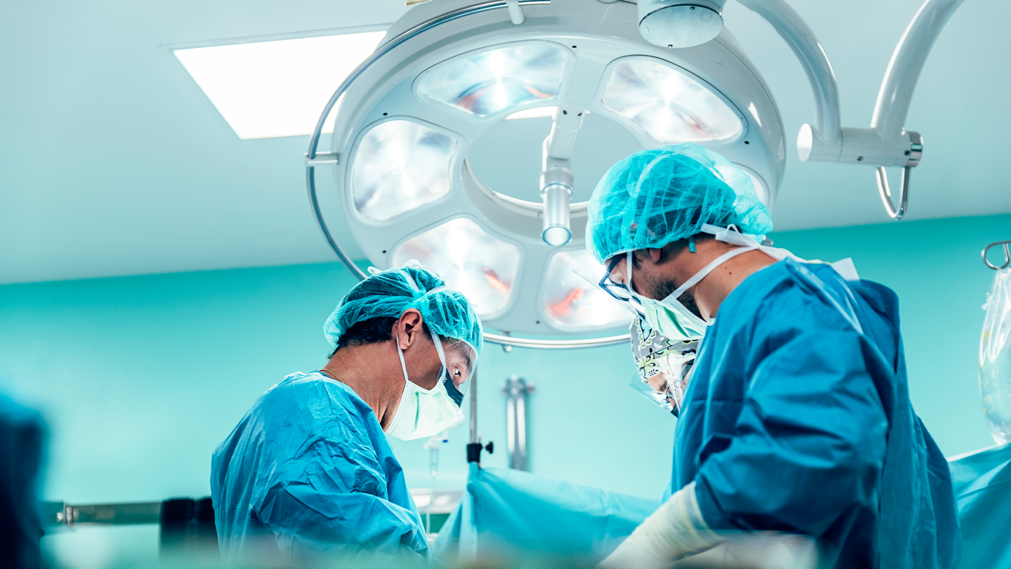 Two surgeons operating in an operating room.
