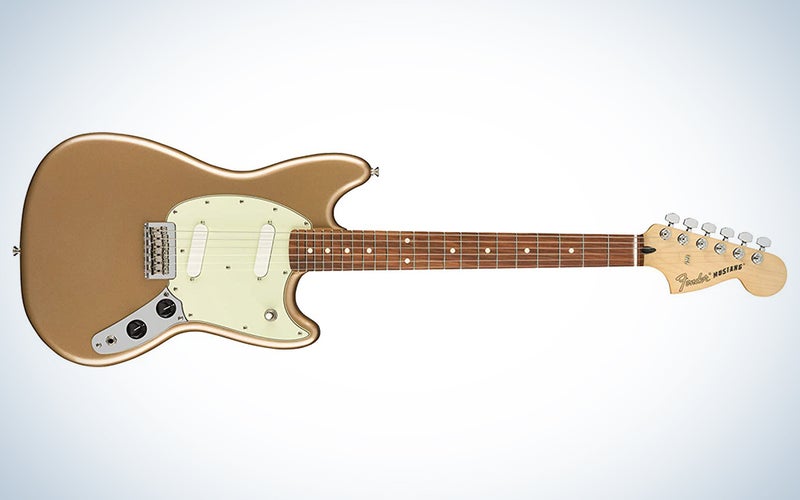 A gold Fender Mustang electric guitar on a blue and white background