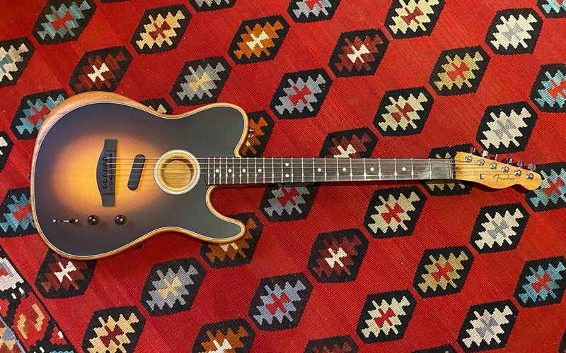 Fender Acoustasonis hybrid acoustic-electric guitar on a Southwestern rug