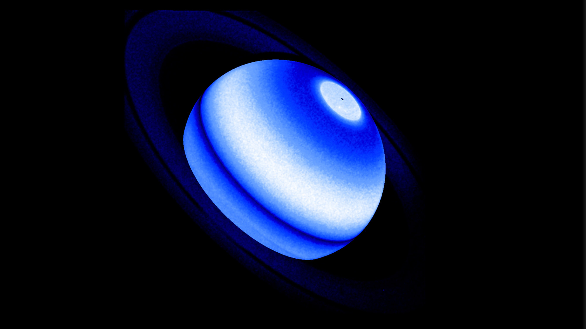 A blue UV image of the planet Saturn.