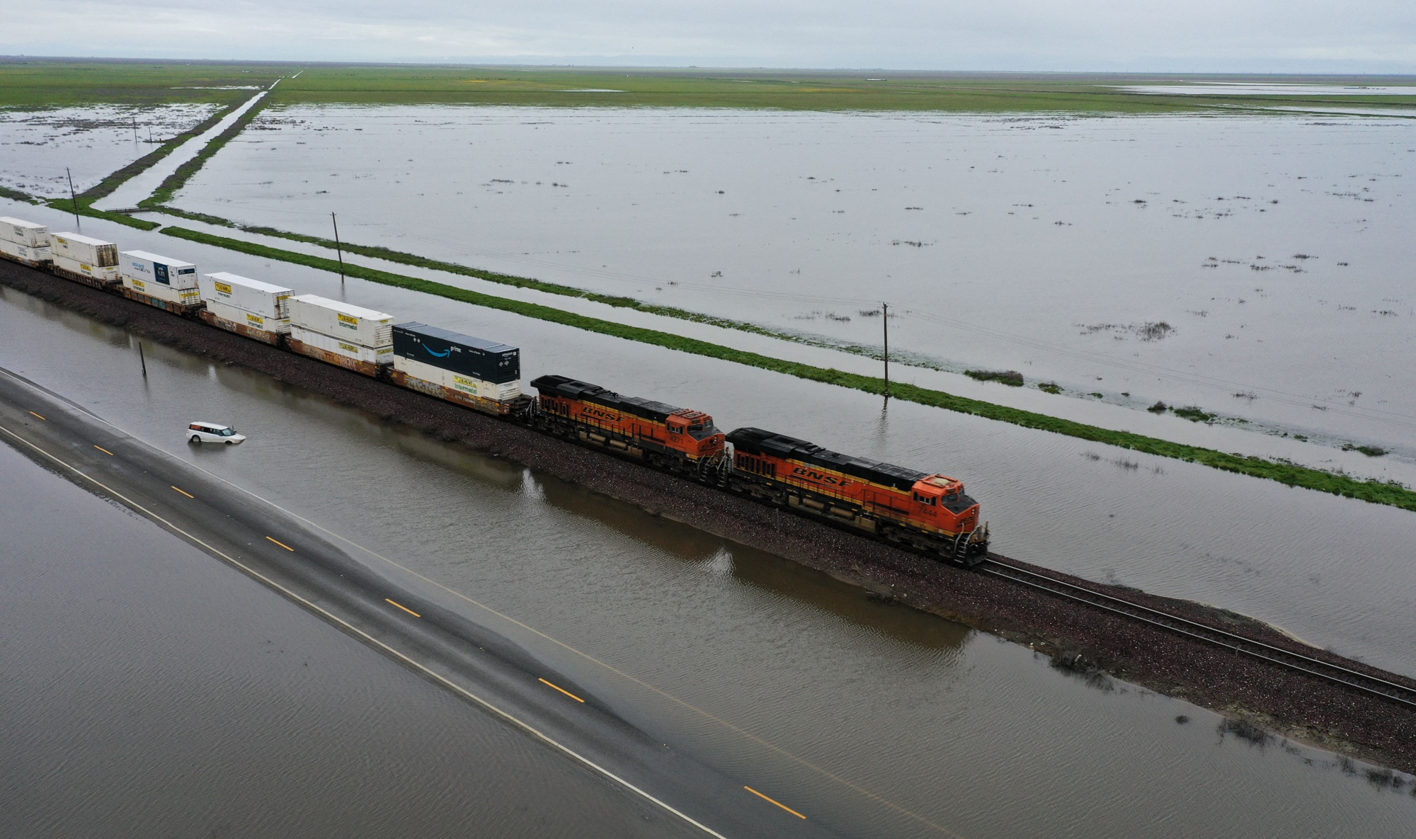 Tulare Lake flooding stalls a train after severe rainstorms from the atmospheric river in California Central Valley in March 2023