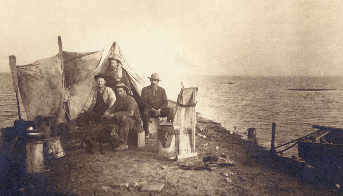 Settlers camping on the shores of Tulare Lake, California, in the late 1800s. Black and white image.