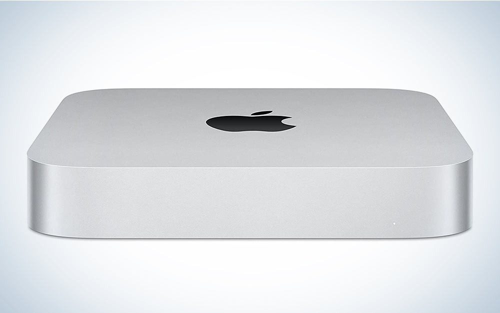 A grey Apple Mac Mini on a blue and white background