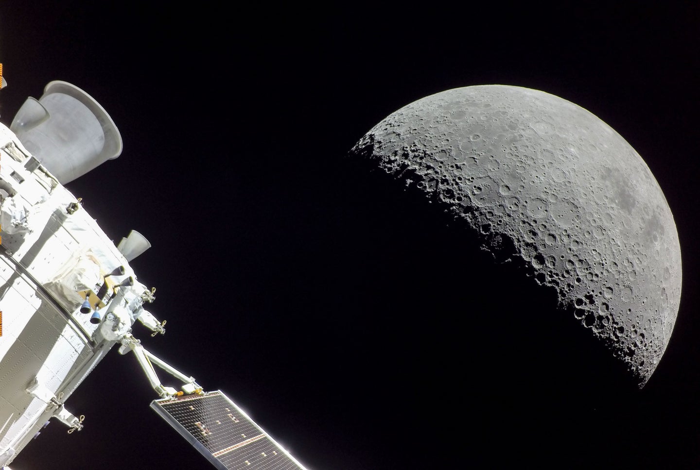 Orion space capsule capturing surface of moon during NASA Artemis I mission
