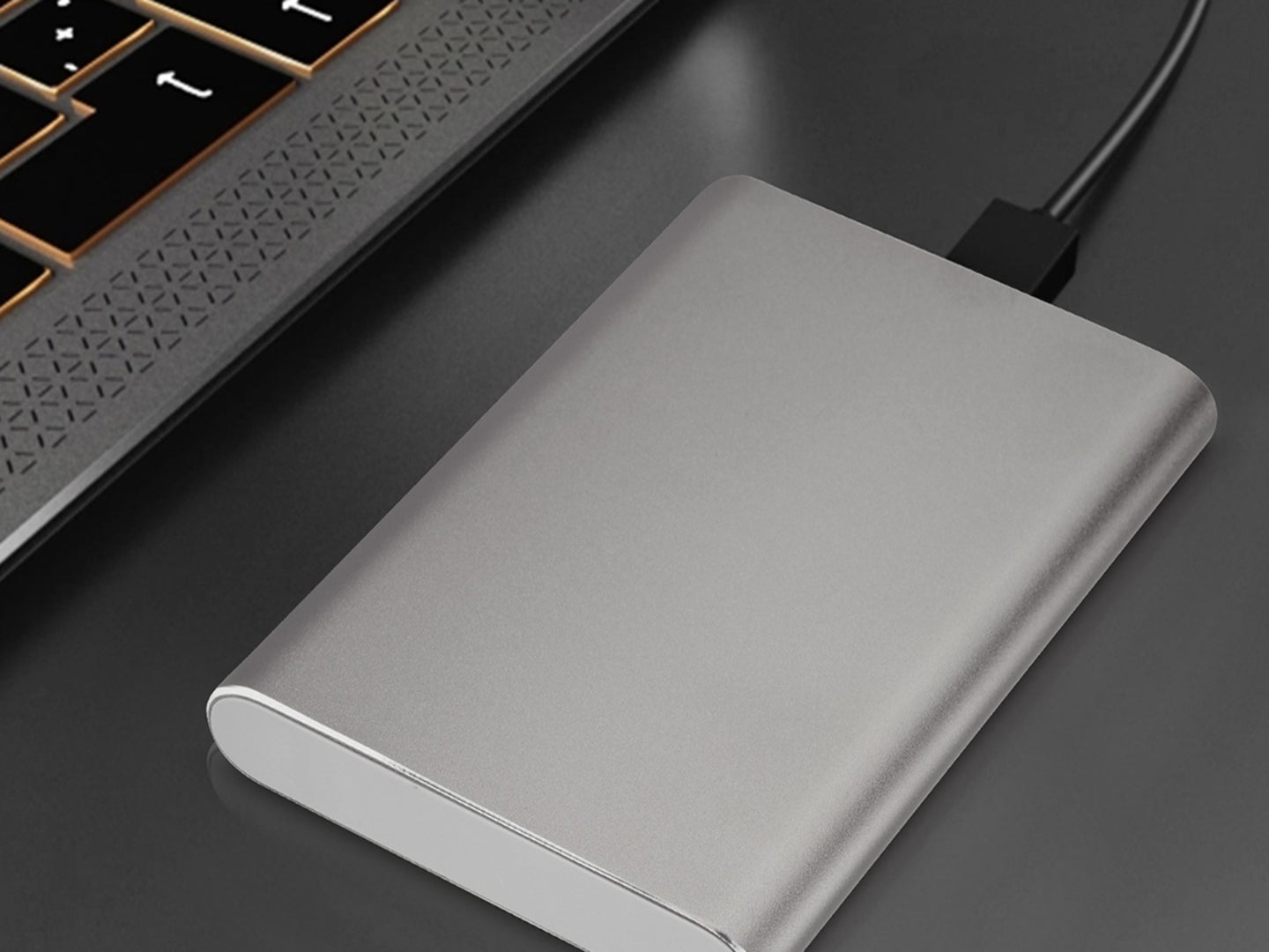 A silver hard drive on a desk